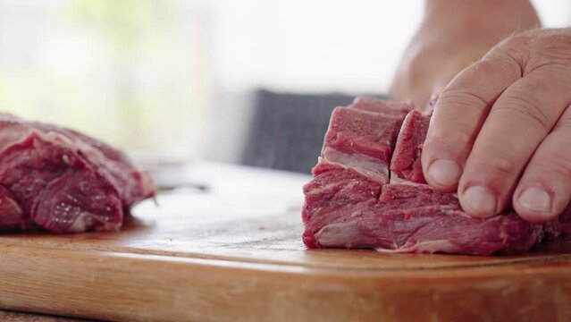 Cook at Traditional Churrasco Brazilian Barbecue. Preparing and cutting Ancho meat. Home Grill from Brazil
