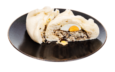 cut Banh Bao steamed bun with chicken, vegetables, egg, mushrooms, funchose on plate cutout on white background