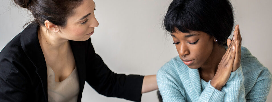 Horizontal banner or header with caucasian woman therapist providing psychological help to female african american patient, comforting her - Treatment of emotional and mood disorders