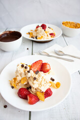 
Ice cream with strawberries and chocolate drizzle. On a wooden background. Dessert