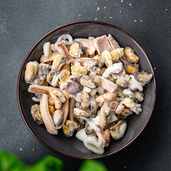 seafood salad frozen food mussels, rapan, octopus, scallop, squid healthy meal food snack on the table copy space food background rustic top view 