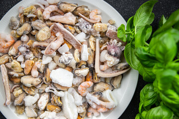 seafood salad frozen food mussels, rapan, octopus, scallop, squid healthy meal food snack on the table copy space food background rustic top view 