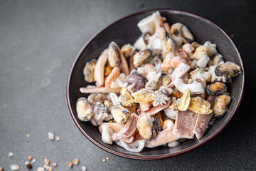 seafood salad frozen food mussels, rapan, octopus, scallop, squid healthy meal food snack on the table copy space food background rustic top view 