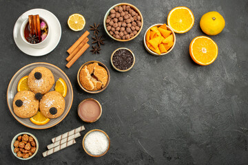 top view yummy cookies with cup of tea and orange slices on dark background cake pie sugar dessert biscuit tea