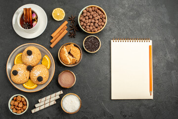 top view yummy cookies with cup of tea on dark grey background cake pie dessert biscuit tea cookie