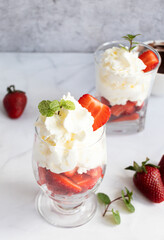 Dessert from whipped cream and fresh strawberries. on a light background