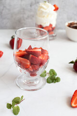 Dessert from whipped cream and fresh strawberries. on a light background
