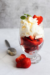 Dessert from whipped cream and fresh strawberries. on a light background