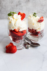Dessert from whipped cream and fresh strawberries. on a light background