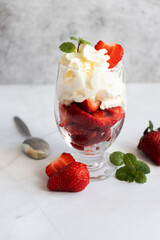 Dessert from whipped cream and fresh strawberries. on a light background