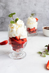 Dessert from whipped cream and fresh strawberries. on a light background