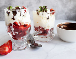 Dessert from whipped cream and fresh strawberries. on a light background