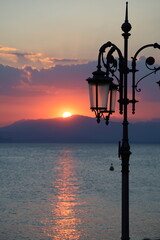 Obraz premium Sunset over lake with lantern