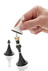 The hand holding the chess piece, the pawn beats the king, Checkmate, Business concept strategy, leadership, victory of white over black, on isolated white background