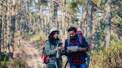 Fototapeta premium Happy Travelers Hiking with Backpacks on the Beautiful Rocky Trail at Warm Sunny. Hikers with backpacks walks in mountains. travel in the mountains with backpacks. Travel in the mountain with backpack