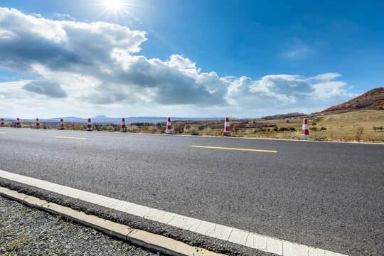 Asphalt road and sky clouds background