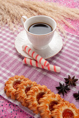 front view cup of tea with cookies and stick candy on pink desk biscuit sugar cookie sweet