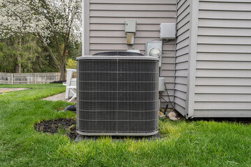 air conditioner condeser unit and system has been installed in a backyard - obrazy, fototapety, plakaty