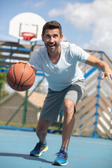 handsome male playing basketball outdoor