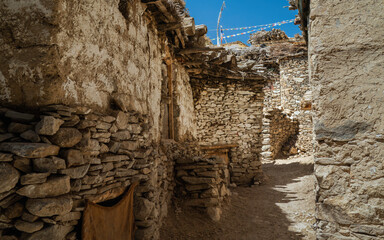 Path through village flanked by dry stone walled housing in Nako, Inida.