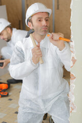 plasterer shaping the wall edge