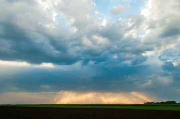 Fototapeta na wymiar Cloudy stormy sky with sun rays