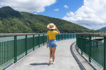 Travel woman walk along the pier