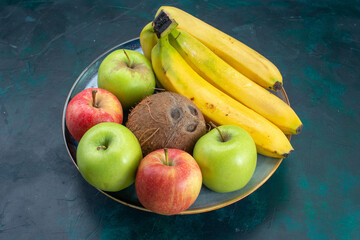 front view different fruit composition coconut apples and bananas on dark-blue desk fruit fresh mellow exotic tropical