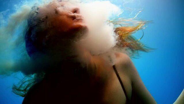 possessed by devil or demon woman diving in water depth, mysterious and fabulous underwater shot