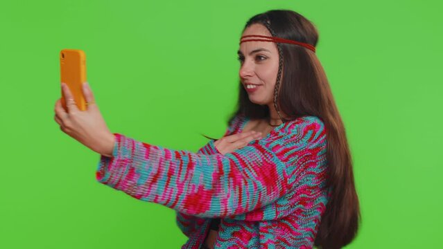 Woman blogger taking selfie vlog on smartphone, communicating video call online with family or friends, live translation stream. Pretty hippie girl isolated on chroma key background, green screen