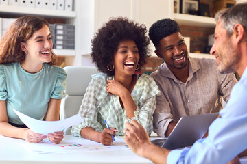 Male And Female Business People With Laptop Meeting In Modern Office