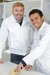 Obraz premium painter and young apprentice looking at the camera