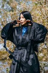 Young asian woman with long hair  wearing black kimono 