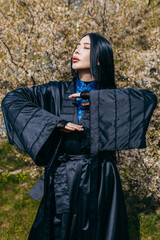 Young asian woman with long hair  wearing black kimono 