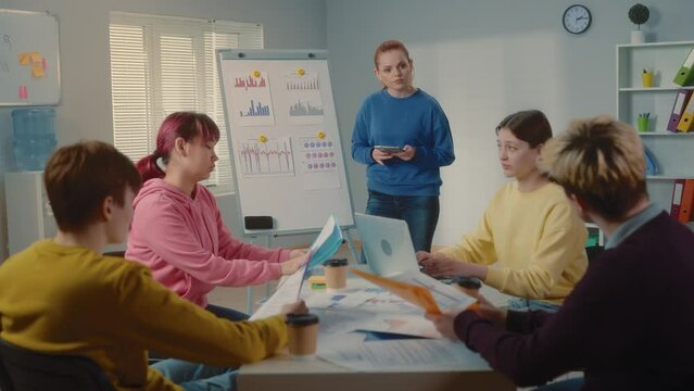 Young diverse business team work together in project brainstorm meeting. Cooperate teamwork, strategy planning, small business startup company, or office coworker collaborate concept.