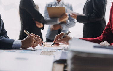 Brainstorming Collaboration and successful partnership analysis by Young business Asian people working in an office workspace