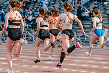 rear view group female athlete runners running sprint race, summer athletics championships