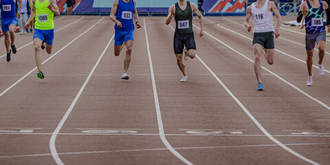 group male athlete runners running sprint race, they run into finish line, summer athletics...