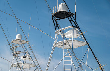 Tuna Towers of two sport fishing yachts moored next to each other in a marina. Used for spotting fish swimming near the waters surface.