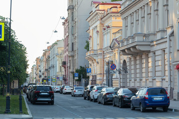 View of street with houses, cars and old buildings of city in the Saint Petersburg. City street on a summer evening