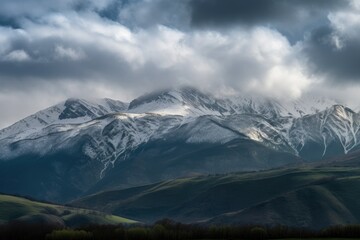 Fototapeta premium majestic mountain range, with clouds rolling over the peaks, created with generative ai