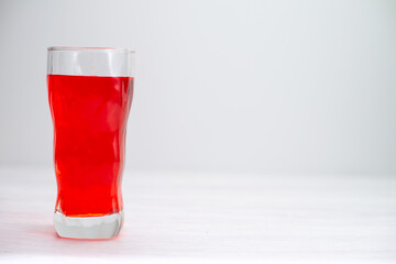 front view red juice icing drink red colored inside long glass on the white desk juice fruit drink cocktail