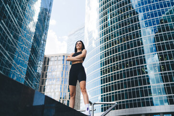 Strong sportswoman relaxing in downtown