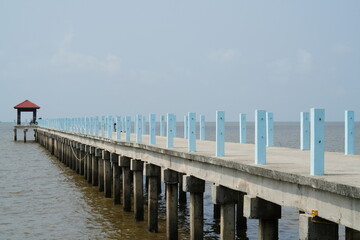 Fototapeta na wymiar Seascape, pier perspective and blue sky in sunny day.