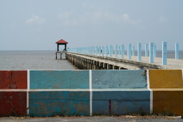 Seascape, pier perspective and blue sky in sunny day.