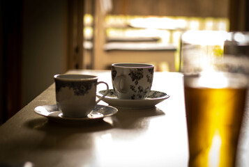 Two cups of coffee and glass of beer on a Caffe table 