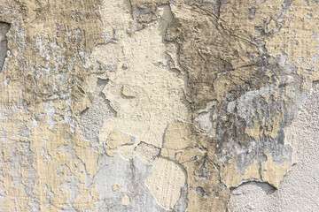 Old concrete wall with peeling paint.