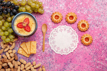 top view delicious creamy dessert with fresh grapes cookies and peanuts on light-pink background dessert ice-cream berry cream sweet fruit