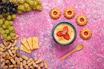 top view delicious creamy dessert with fresh grapes cookies crackers and peanuts on light-pink background dessert ice-cream berry cream sweet fruit