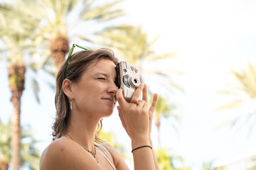 Turist women with old camera miami beach vacation